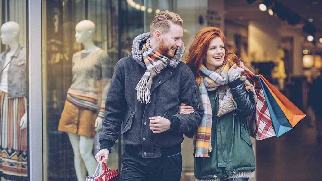 Man and woman strolling with shopping bags